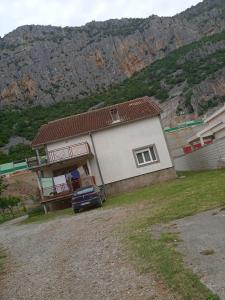 a house with a car parked in front of it at Villa Natalija in Podgorica