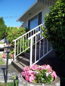 a house with stairs and flowers in front of it at Serenity in Burnaby