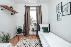 a bedroom with two beds and a window at Dream for 4 - Smart TV in Krefeld