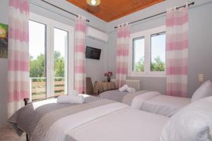 two beds in a room with two windows at SOHORO Forest Hill Apartment by "elite" in Kampion +31 photos