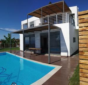 a villa with a swimming pool and a house at villa kate view in Ratzaklíon