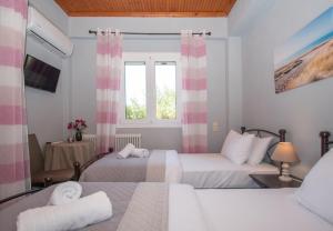 a hotel room with two beds and a window at SOHORO Forest Hill Apartment by "elite" in Kampion