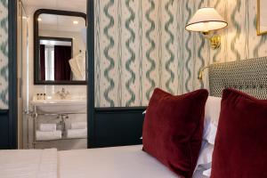 a hotel room with a bed and a sink at Hotel du Champ de Mars in Paris