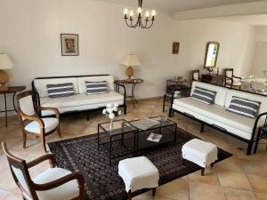 a living room with couches and chairs and a table at Les Terrasses Binel à Ronsac in Aigrefeuille