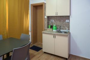 a kitchen with a sink and a table at Skopje Hostel in Skopje