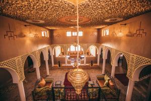 an overhead view of a dining room with a chandelier at Riad Merzouga Dunes in Merzouga