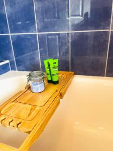 a wooden tray sitting on the edge of a bath tub at Whitepark Cottage - your home away from home in Ballycastle