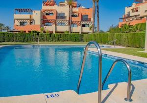a swimming pool in front of a building at Apartamento en Valle del Este in Vera