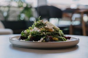 a salad on a plate on a table at Agamemnon Hotel in Nafplio