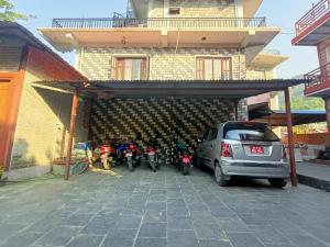 a group of motorcycles parked in front of a building at Thapa Home Stay in Pokhara