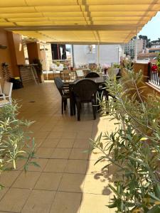 a patio with a table and chairs on a building at Royal Inn Aparthotel in Lloret de Mar