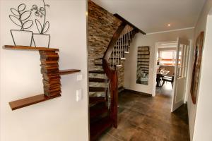 a staircase in a house with a brick wall at Ferien_VILLA EASY LIVING in Göhren-Lebbin