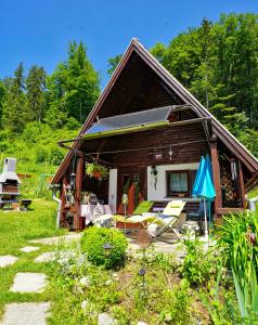 a small house with a porch and a patio at Emerald Bell Cottage - Smaragdni Zvonček 