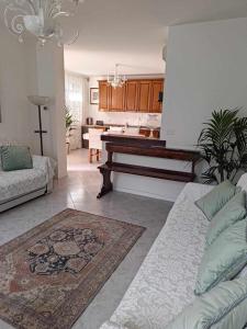 a living room with a couch and a piano at TRAGHETTO VECCHIO HOUSE in Cavallino-Treporti