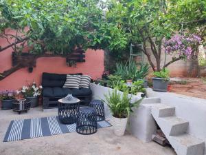 a patio with a couch and some plants and trees at Apartment with garden in Vela Luka