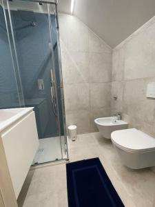 a bathroom with a shower and a toilet and a sink at Le Vele Luxury Mini Apartment in Chioggia +17 photos