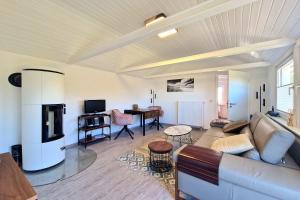 a living room with a couch and a table at Bungalow "Refugium" in Ostseebad Sellin