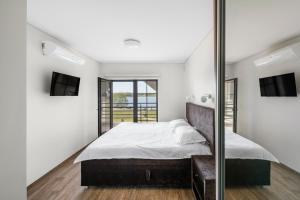 a bedroom with a bed and a mirror at Reketijos Dvaras in Reketija +128 photos