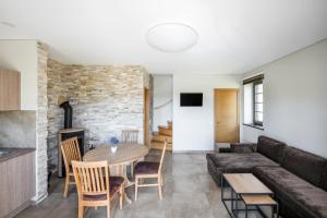 a living room with a couch and a table at Reketijos Dvaras in Reketija