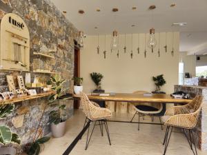 a restaurant with a bar with chairs and a stone wall at Dias Hotel & Apts in Stalís