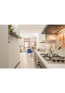 a kitchen with a sink and a stove top oven at Casa Cinisi - Casa Vacanze in Cinisi