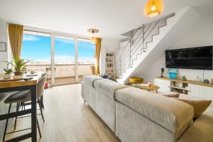 a living room with a large couch and a table at Top Central Maisonette with Underground parking in Sofia