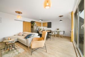 a living room with a couch and a dining room at Top Central Maisonette with Underground parking in Sofia