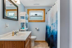 a bathroom with a sink and a toilet at Moe's Vineyard - Cabin in Necedah +26 photos