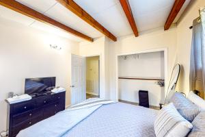 a bedroom with a large bed and a tv at Jacques Tranquility in Fort Oglethorpe