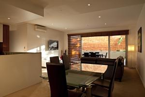a dining room and living room with a table and chairs at Brighton Bay Apartments in Melbourne