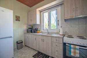 a kitchen with a sink and a stove and a window at SOHORO Forest Hill Apartment by "elite" in Kampion
