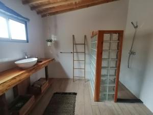 a bathroom with a sink and a shelf and a window at Casa C'alma in Ponta Delgada