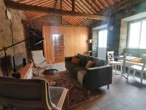 a living room with a couch and a table at Casa C'alma in Ponta Delgada