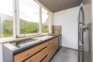 a bathroom with a sink and a window at House Coso in Podšpilje