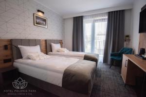 Postel nebo postele na pokoji v ubytování Hotel Polonia PARK Medical Center & Spa