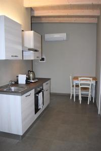 a kitchen with a sink and a table at Black & White - My Place Malpensa in Cairate