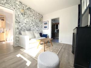 sala de estar con sofá blanco y mesa en Appartements chaleureux - 15 min à pied de la gare, en Le Havre