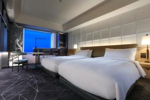 Кровать или кровати в номере Tokyo Dome Hotel