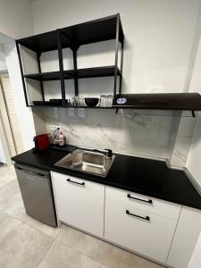 a kitchen with a sink and a counter top at Lighthouse Rooms in Kriopigi