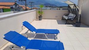 a pair of blue chairs on a balcony at Homing Volos Exclusive Luxury Residence in Volos