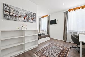 a white room with a desk and a bed at Appartment Maria Friedrichshafen Bodensee in Friedrichshafen