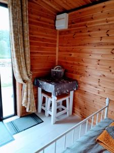 a room with a table in a log cabin at The Hut B & B in Mochdre
