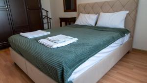 a bedroom with a bed with two towels on it at Spacious Villa with Sea and Mountain View in Kemer
