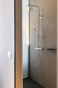 a shower with a glass door in a bathroom at Apartments and Rooms Lejletul in Dubrovnik