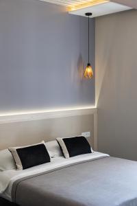 a bed with two pillows on it in a room at Apartments and Rooms Lejletul in Dubrovnik