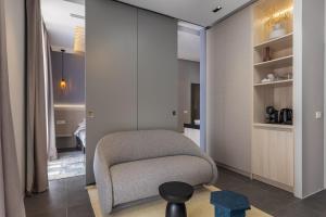 a living room with a chair in a room at Apartments and Rooms Lejletul in Dubrovnik