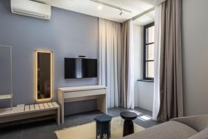 a living room with a couch and a mirror at Apartments and Rooms Lejletul in Dubrovnik