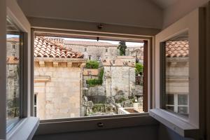 a window with a view of the old city at Apartments and Rooms Lejletul in Dubrovnik