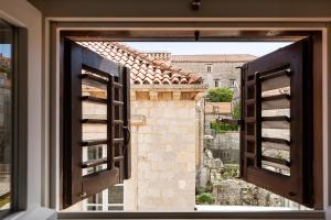 an open window with a view of a castle at Apartments and Rooms Lejletul in Dubrovnik