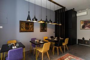 a dining room with tables and chairs and lights at Apartments and Rooms Lejletul in Dubrovnik